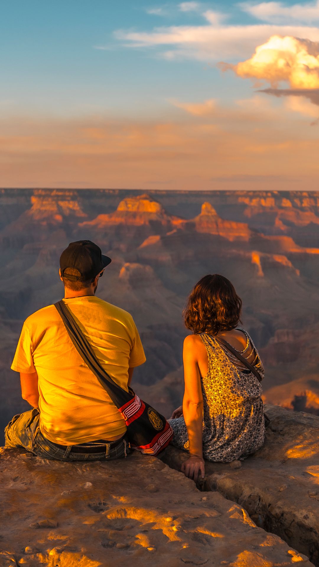 Couple looking out to the Grand Canyon at sunset